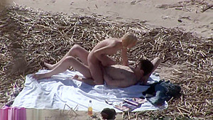 Couple fucks at the beach while guy masturbates